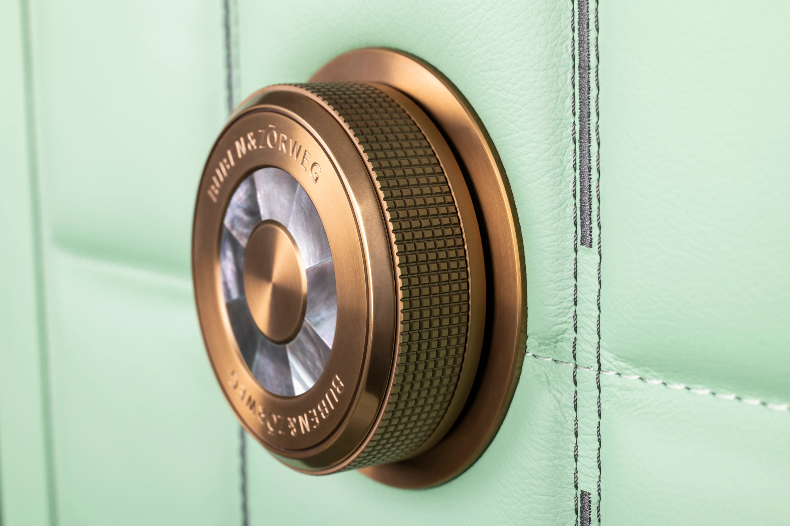 Close-up of the precision-engineered bronze-gold dial lock on the BUBEN&ZORWEG ORION high-security safe in mint green. — BUBEN&ZORWEG